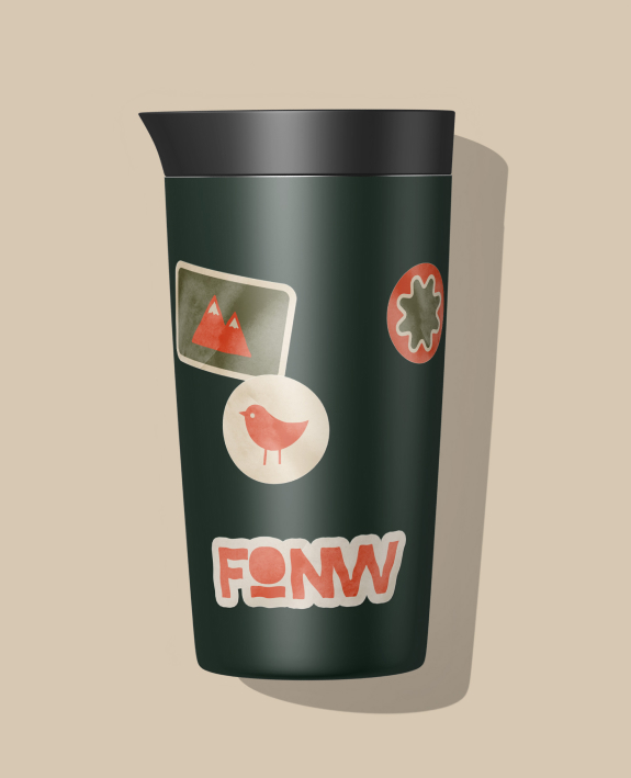 Coffee cup with stickers on it.